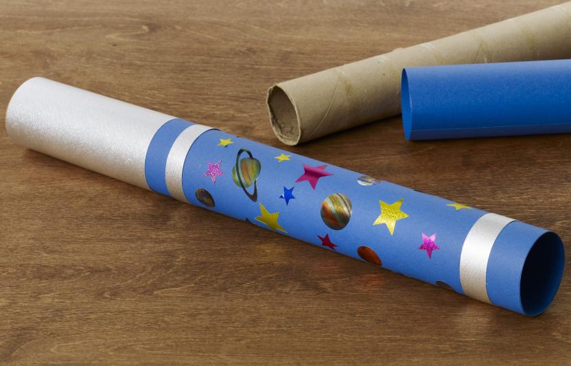 Cardboard tube telescope with decorations.