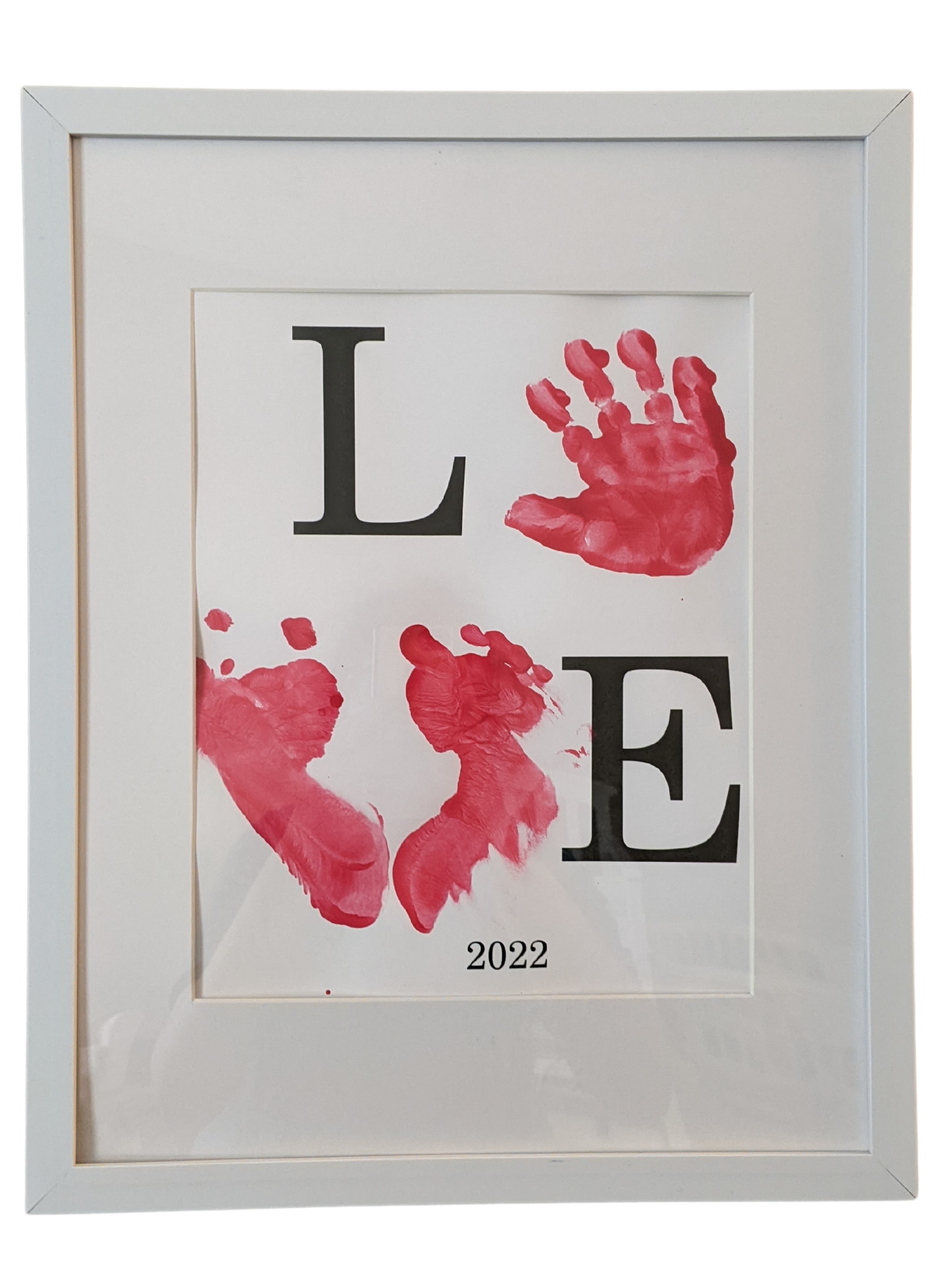 Framed print with L - baby handprint as O - baby footprints as V - E