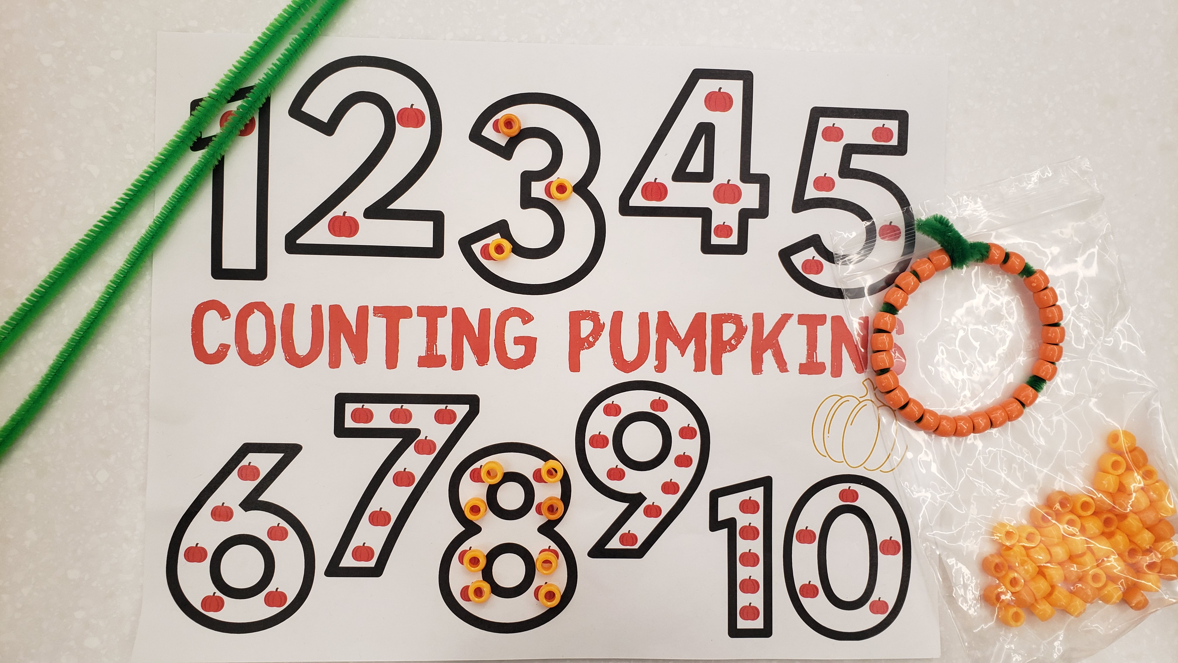 Pumpkin Counting text and orange pony bead counters in number outlines