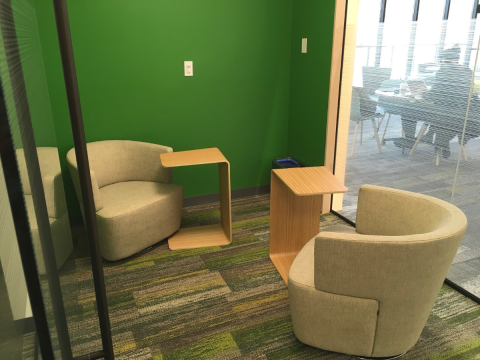 Study Room D with green walls and two desks next to chairs