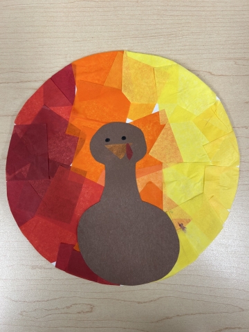 Circular turkey craft with tissue paper as the feathers.